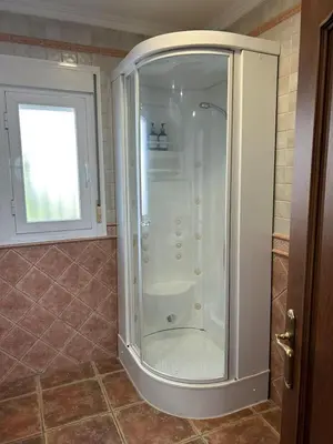 a shower with a glass door in a bathroom at Villa Atlántida-Playa La Barrosa in Chiclana de la Frontera