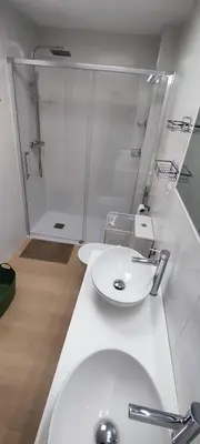 a bathroom with a white sink and a shower at Cruces by LiveWork in El Puerto de Santa María