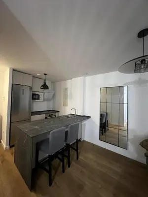 a kitchen with a large island in the middle of a room at Ático Roomy in Jerez de la Frontera