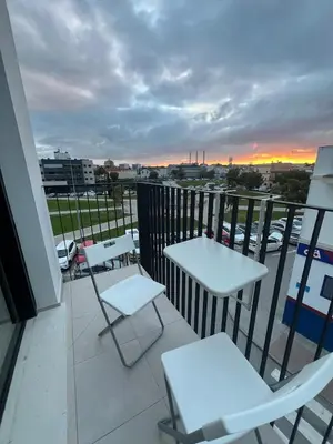 a balcony with two tables and chairs on a building at Ático Roomy in Jerez de la Frontera