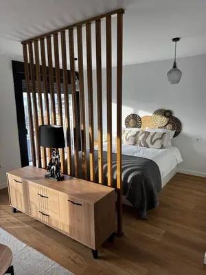 a bedroom with a large bed with a wooden crib at Ático Roomy in Jerez de la Frontera