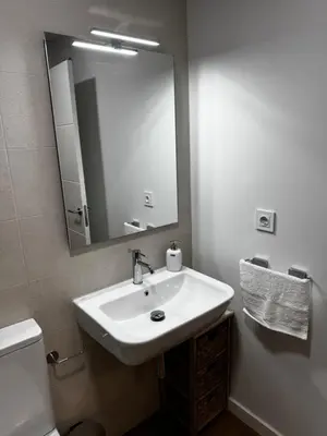 a bathroom with a sink and a mirror at Ático Roomy in Jerez de la Frontera