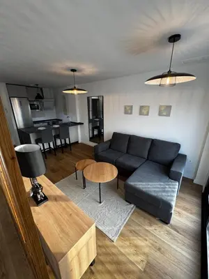 a living room with a couch and a table at Ático Roomy in Jerez de la Frontera
