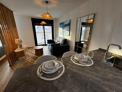 a living room with a table with plates and glasses on it at Estudio Roomy Jerez in Jerez de la Frontera