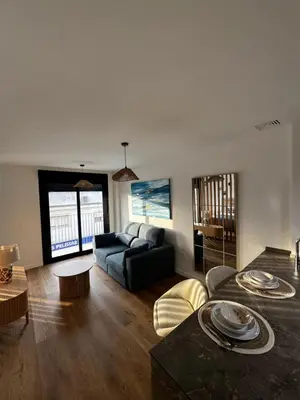 a living room with a couch and a table at Estudio Roomy Jerez in Jerez de la Frontera