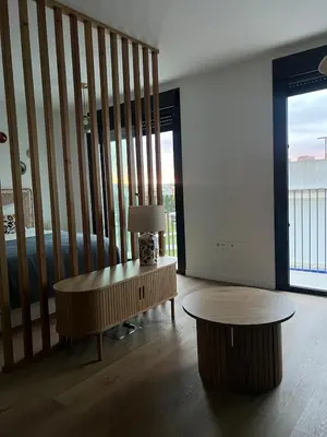 a living room with a table and a couch at Estudio Roomy Jerez in Jerez de la Frontera