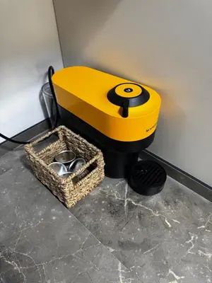 a yellow toilet sitting next to a basket of shoes at Estudio Roomy Jerez in Jerez de la Frontera