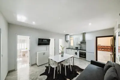 a living room with a couch and a table at Apartamento Luz de Cádiz in Cádiz