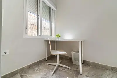 a desk with a chair next to a window at Apartamento Luz de Cádiz in Cádiz