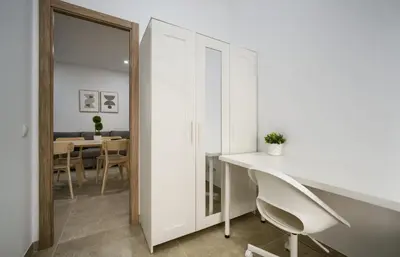 a white room with a white desk and a mirror at Apartamento Playa de Cádiz in Cádiz
