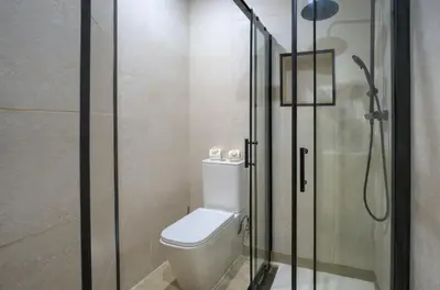 a bathroom with a toilet and a glass shower at Apartamento Playa de Cádiz in Cádiz