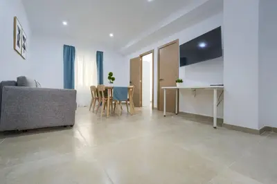 a living room with a couch and a table at Apartamento Playa de Cádiz in Cádiz