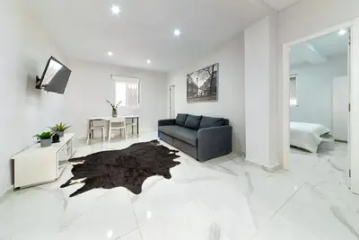 a living room with a couch and a table at Apartamento Luz de Gadir in Cádiz