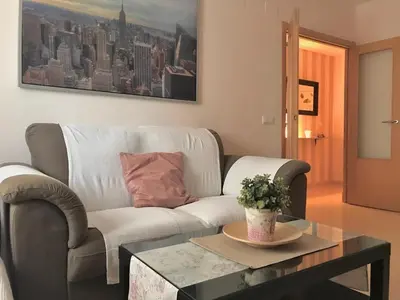 a living room with a couch and a coffee table at Renfurbis apartment in Jerez de la Frontera