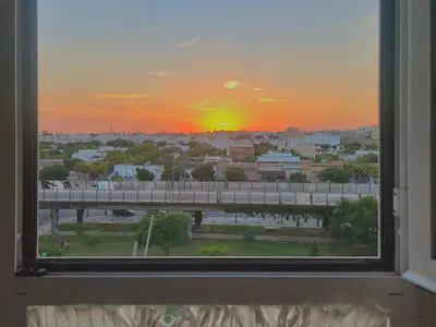 a view of a sunset from a window at Renfurbis apartment in Jerez de la Frontera