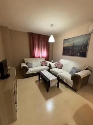 a living room with a couch and a table at Renfurbis apartment in Jerez de la Frontera