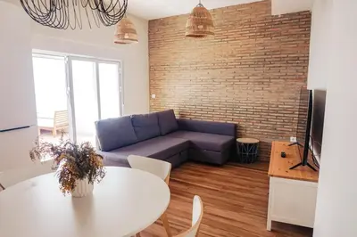 a living room with a couch and a table at Apartamento en pleno centro de Jerez con patio privado in Jerez de la Frontera