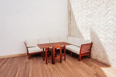 a room with a table and two chairs and a couch at Apartamento en pleno centro de Jerez con patio privado in Jerez de la Frontera