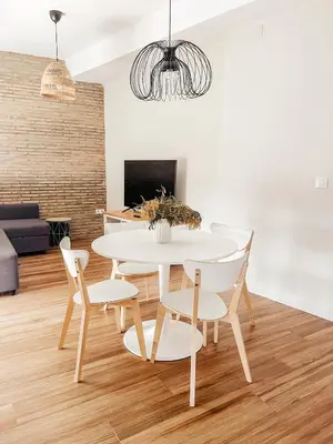 a dining room with a white table and chairs at Apartamento en pleno centro de Jerez con patio privado in Jerez de la Frontera