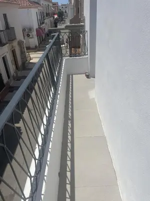 a balcony with a railing on a building at YourHouse Apartamentos Andasol 1D in Chipiona