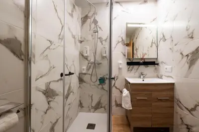 a bathroom with a shower and a sink at YourHouse Apartamentos Andasol 1D in Chipiona