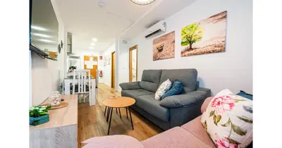 a living room with a couch and a table at YourHouse Apartamentos Andasol BB in Chipiona
