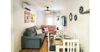 a living room with a couch and a table at YourHouse Apartamentos Andasol BB in Chipiona