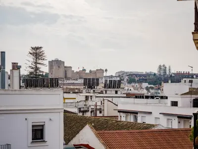 a view of a city from the roofs of buildings at Winahost Apartamento Sanlúcar de Barrameda in Sanlúcar de Barrameda