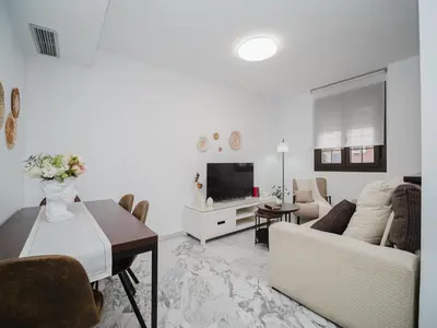 a living room with a couch and a table at Winahost Apartamento Sanlúcar de Barrameda in Sanlúcar de Barrameda