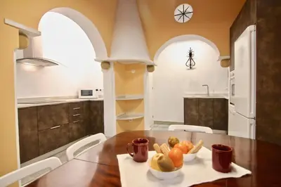 a kitchen with a table with a bowl of fruit on it at El Palacete del Puerto in El Puerto de Santa María