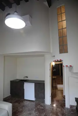 a room with a kitchen and a living room at El Palacete del Puerto in El Puerto de Santa María