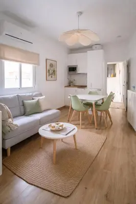 a living room with a couch and a table at El Olivar de Sol in Jerez de la Frontera