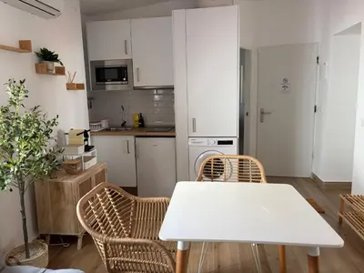 a white kitchen with a washing machine in it at El Olivar de Sol in Jerez de la Frontera