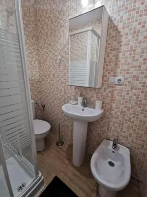a bathroom with a sink and a toilet and a mirror at CDZ - Buenos Aires en Cádiz in Cádiz