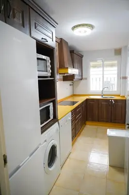 a kitchen with a washer and dryer in it at Bajamar in Sanlúcar de Barrameda