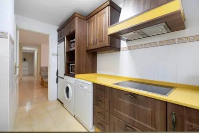 a kitchen with a sink and a washer and dryer at Bajamar in Sanlúcar de Barrameda