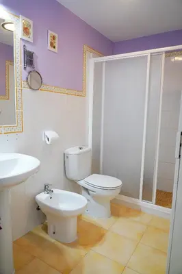 a bathroom with a toilet and a sink at Bajamar in Sanlúcar de Barrameda