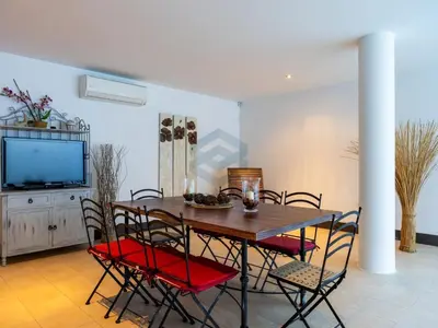 a dining room with a table and chairs and a tv at Villa Sol Sal free parking by Staycare in Rota