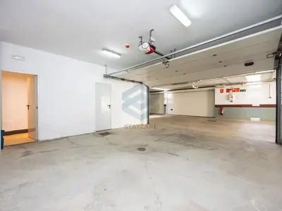 an empty parking garage with two garage doors at Villa Sol Sal free parking by Staycare in Rota