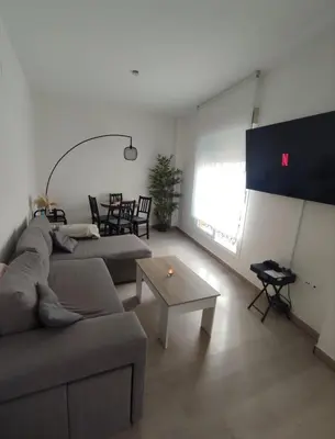 a living room with a couch and a table at Moderno apartamento en el centro de Jerez in Jerez de la Frontera