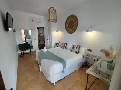 a bedroom with a white bed in a room at Hotel Pozo Rey by Youroom in Chipiona
