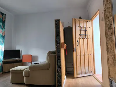 a living room with a door leading into a room at Chiclanero Loft in Chiclana de la Frontera