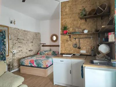 a kitchen with a bed and a sink in a room at Chiclanero Loft in Chiclana de la Frontera