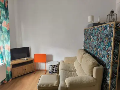 a living room with a couch and a tv at Chiclanero Loft in Chiclana de la Frontera