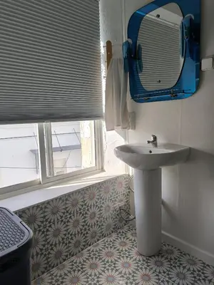 a bathroom with a sink and a window at Chiclanero Loft in Chiclana de la Frontera