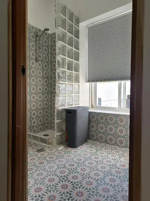 a bathroom with a shower and a trash can at Chiclanero Loft in Chiclana de la Frontera