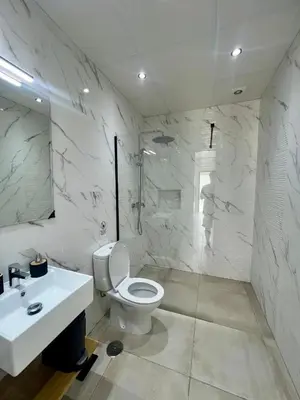 a white bathroom with a toilet and a sink at ChiclanaVillage in Chiclana de la Frontera