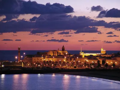 a city at night with lights on the water at Apartamento Centro de Rota La Costilla in Rota