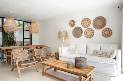a living room with a white couch and a table at Casa junto al mar con piscina 45 in Conil de la Frontera