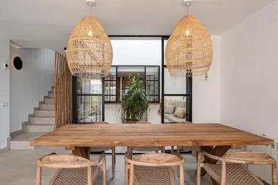 a dining room with a wooden table and chairs at Casa junto al mar con piscina 45 in Conil de la Frontera